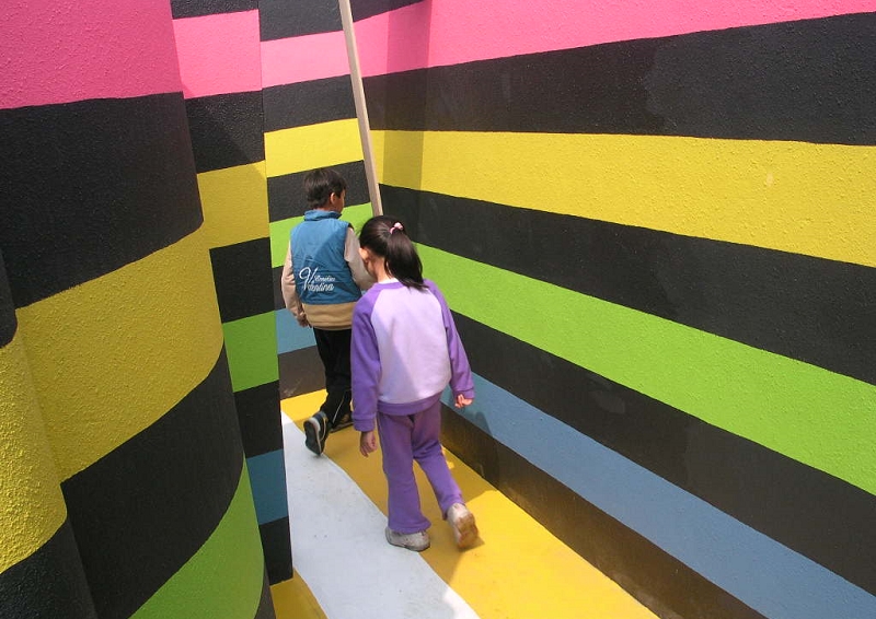 Kids passing the color-striped walls