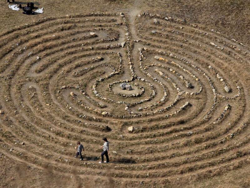 Couple of people walking the labyrinth.