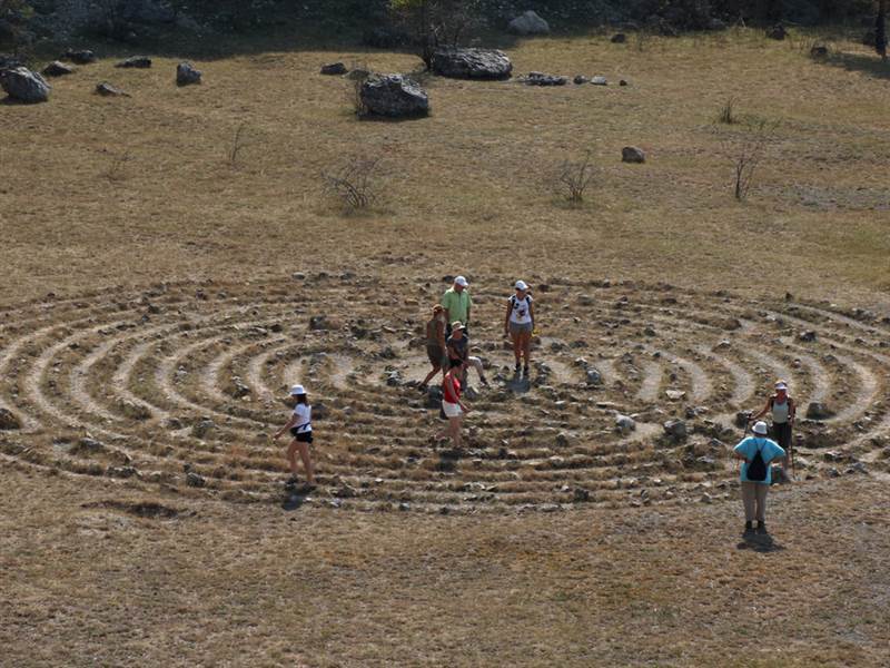 A group of people walking the labyrinth simultaneously.