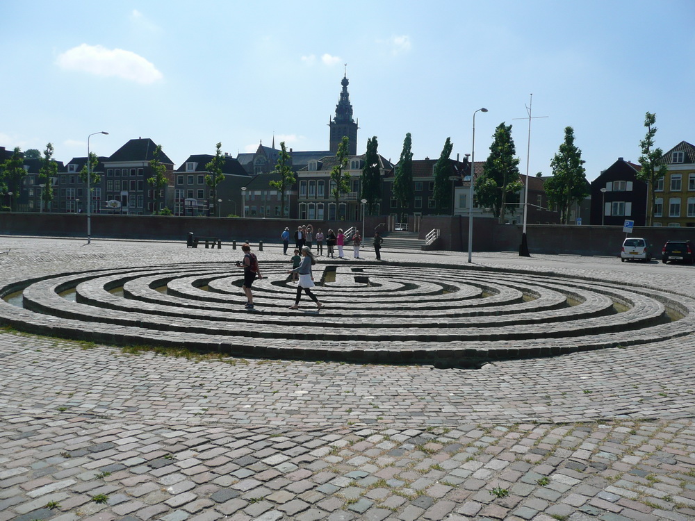 People on the labyrinth, city in the background